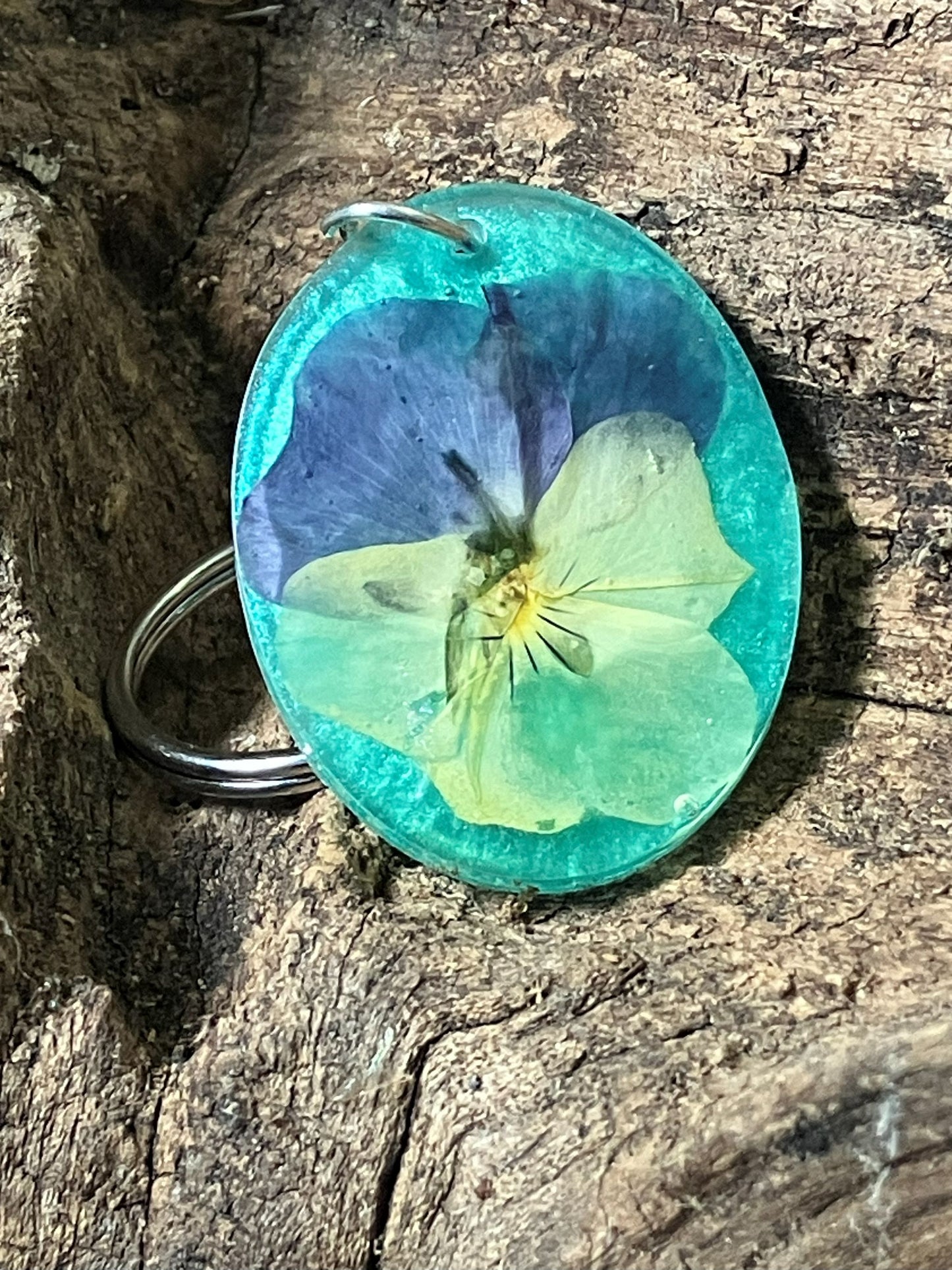 Viola teal resin keychain with real pressed viola flowers, handcrafted by R & D Floral.