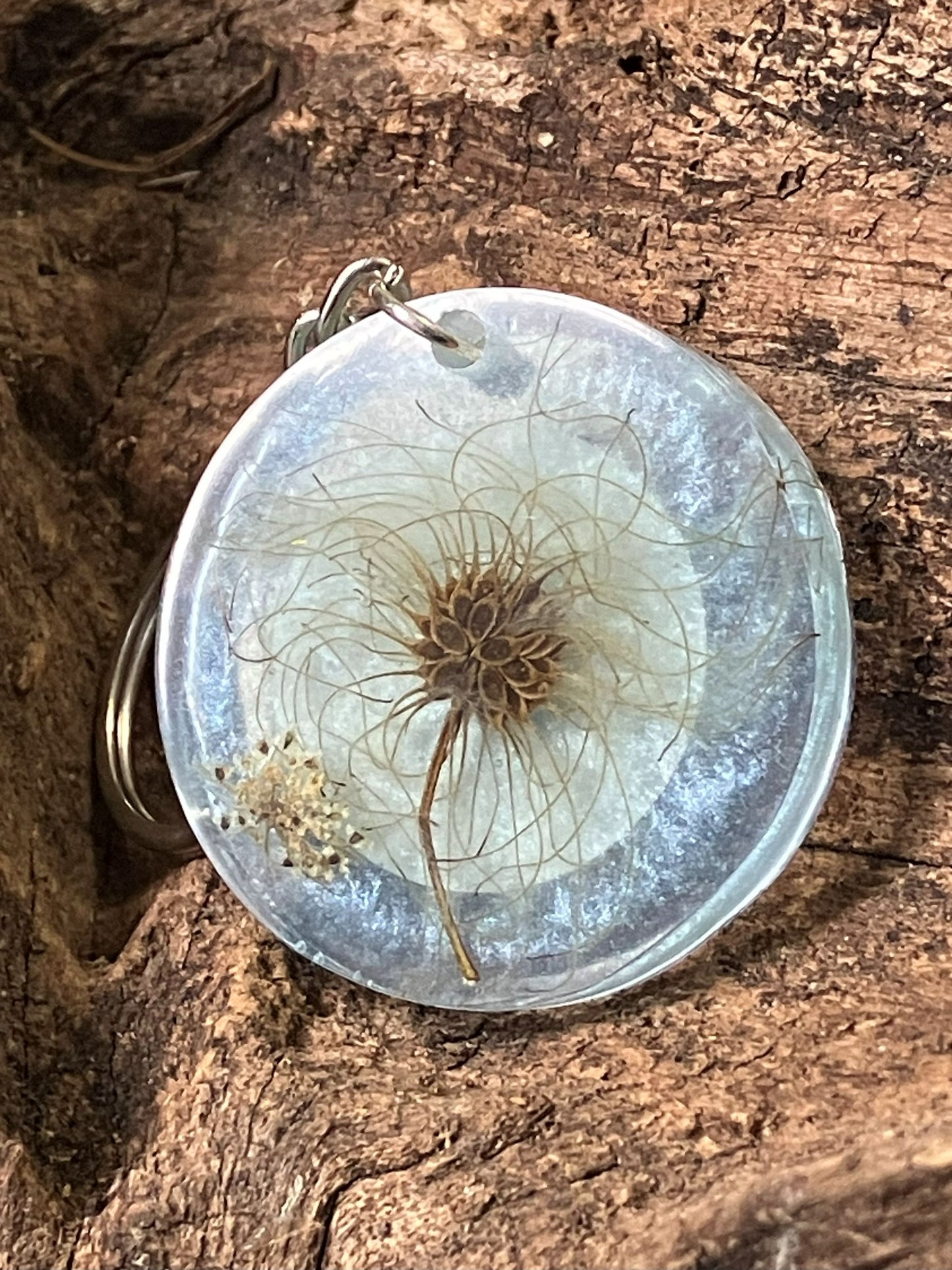 Clear resin keychain with real dandelion seeds preserved inside, handcrafted by R & D Floral.