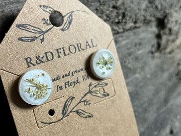 White resin stud earrings encasing real Queen Anne’s Lace flowers handmade by R&D Floral.