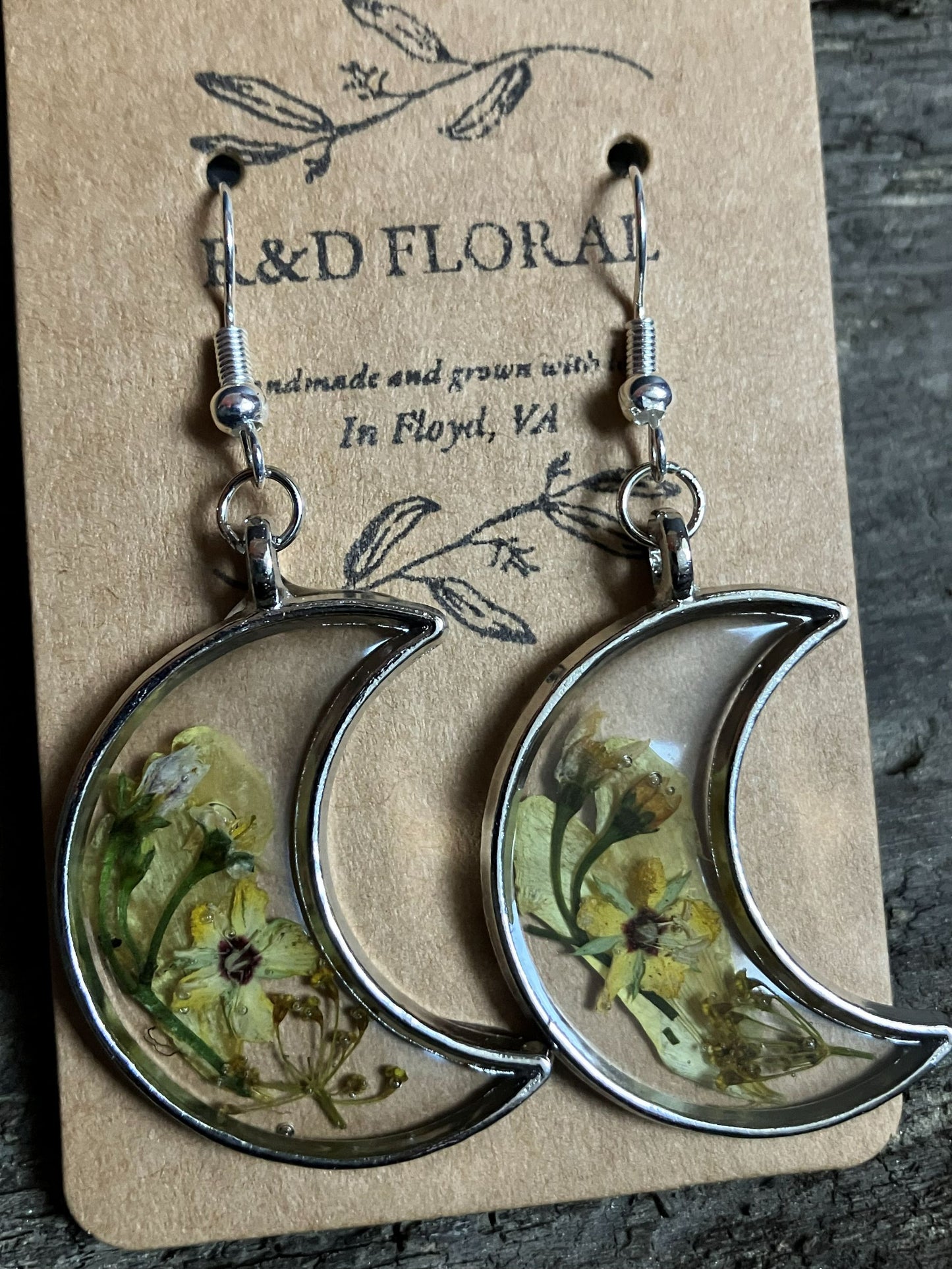 Moon-shaped silver earrings with real Hypericum blooms encased in metal, handmade by R&D Floral.