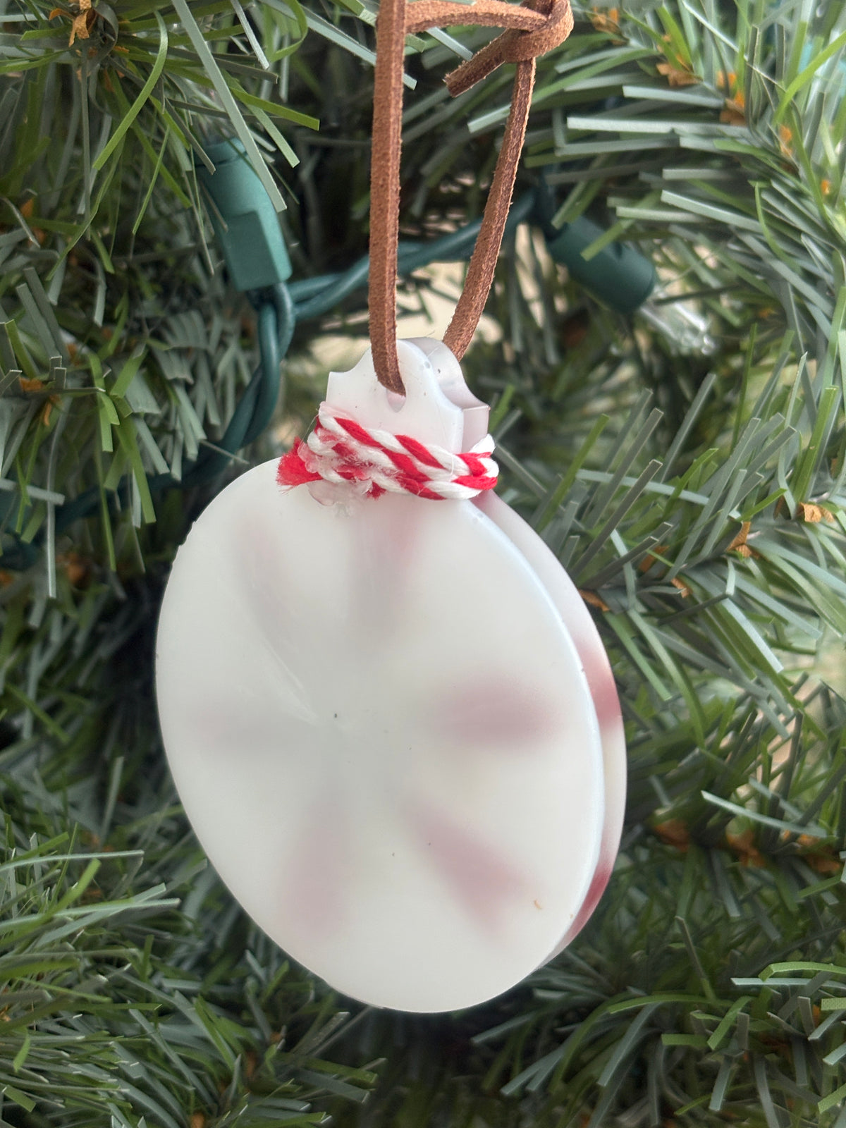 Back of the red Salvia and Queen Anne's Lace snowflake white resin ornament showing the smooth reverse side