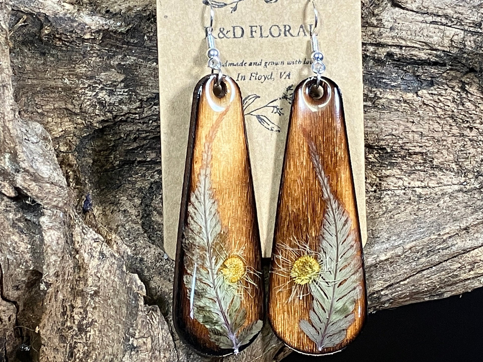 Floral jewelry featuring Japanese Fern Earrings preserved in resin