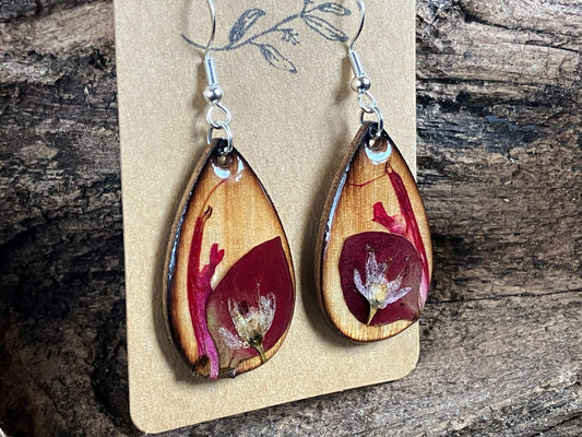 Handmade wooden earrings with real cardinal flower, barberry, and thistle blooms encased in resin by R&D Floral.