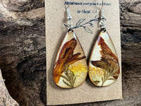 Artisan wooden earrings handmade with real crocosmia, dandelion, and wormwood flowers encased in resin by R & D Floral.