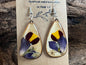 Handcrafted wooden earrings featuring real marigold, salvia, pratia, and Queen Anne’s lace encased in resin by R & D Floral.