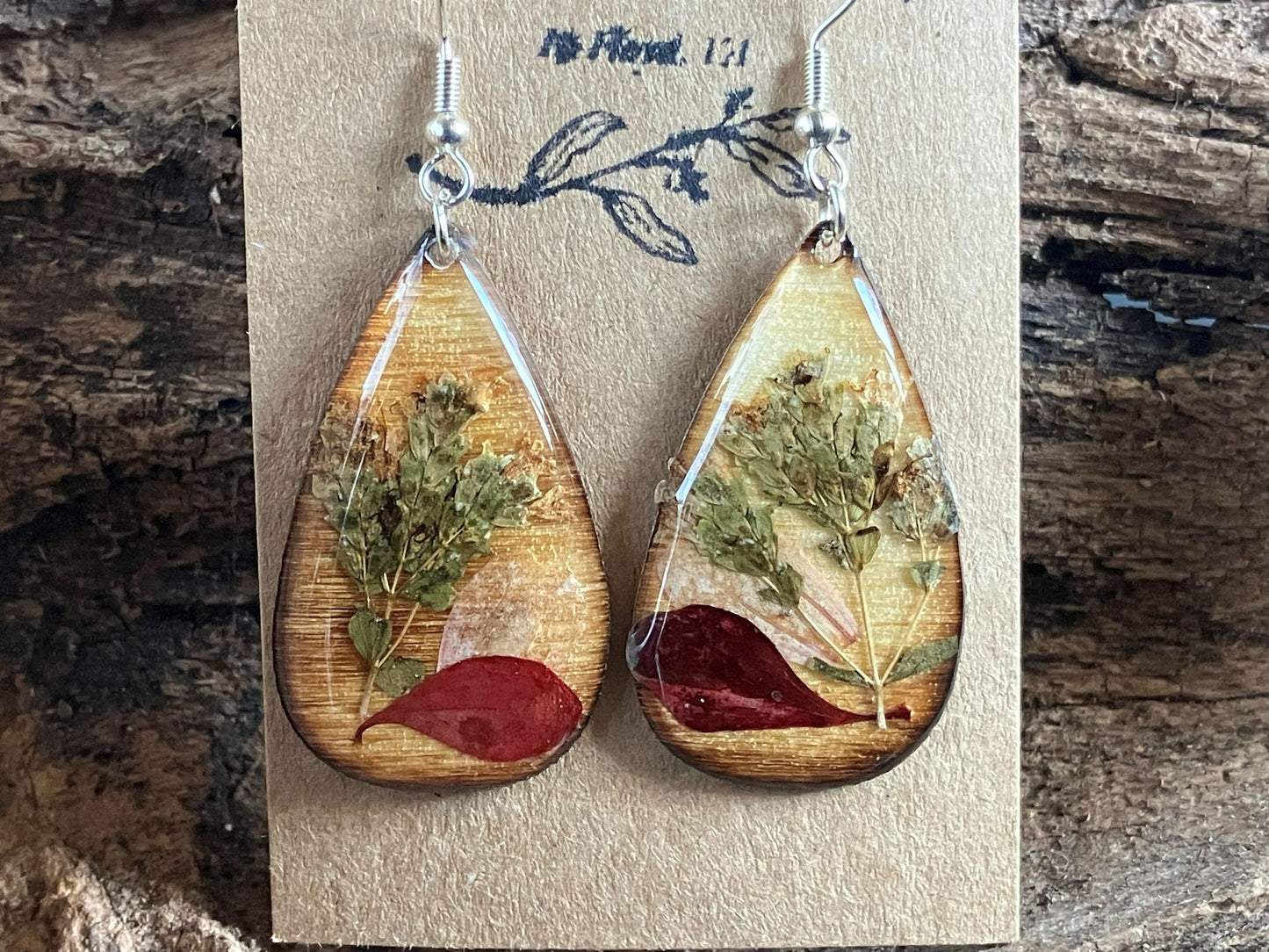 Handmade wooden earrings featuring real oregano, zinnia, and barberry encased in resin by R & D Floral.