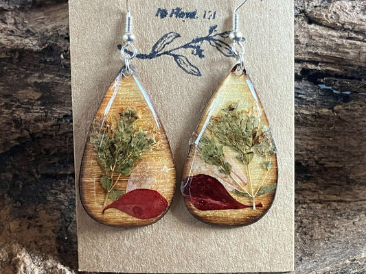 Handmade wooden earrings featuring real oregano, zinnia, and barberry encased in resin by R & D Floral.