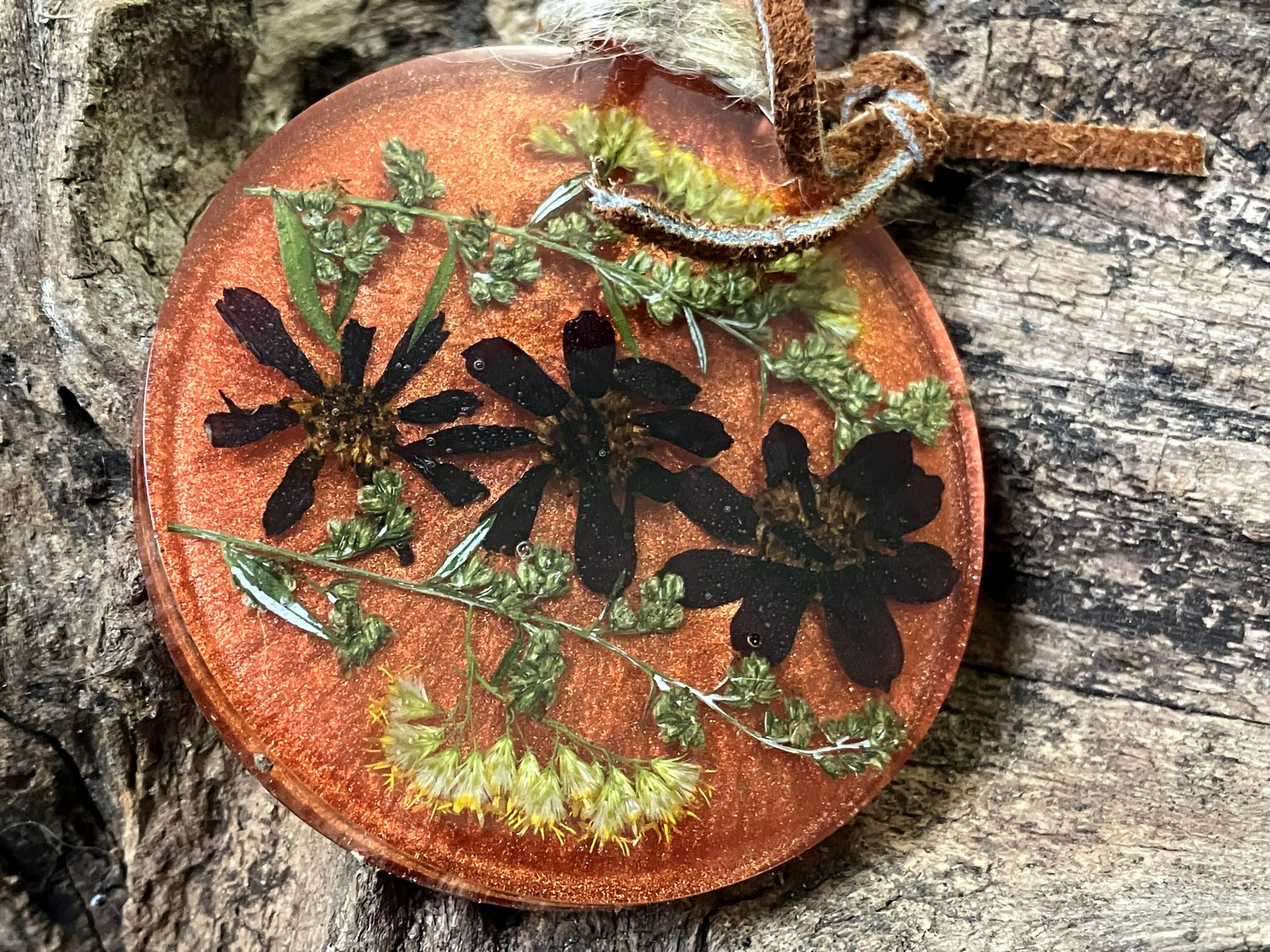 Red zinnia resin flower ornament on a leather cord hanger, handcrafted by R & D Floral.