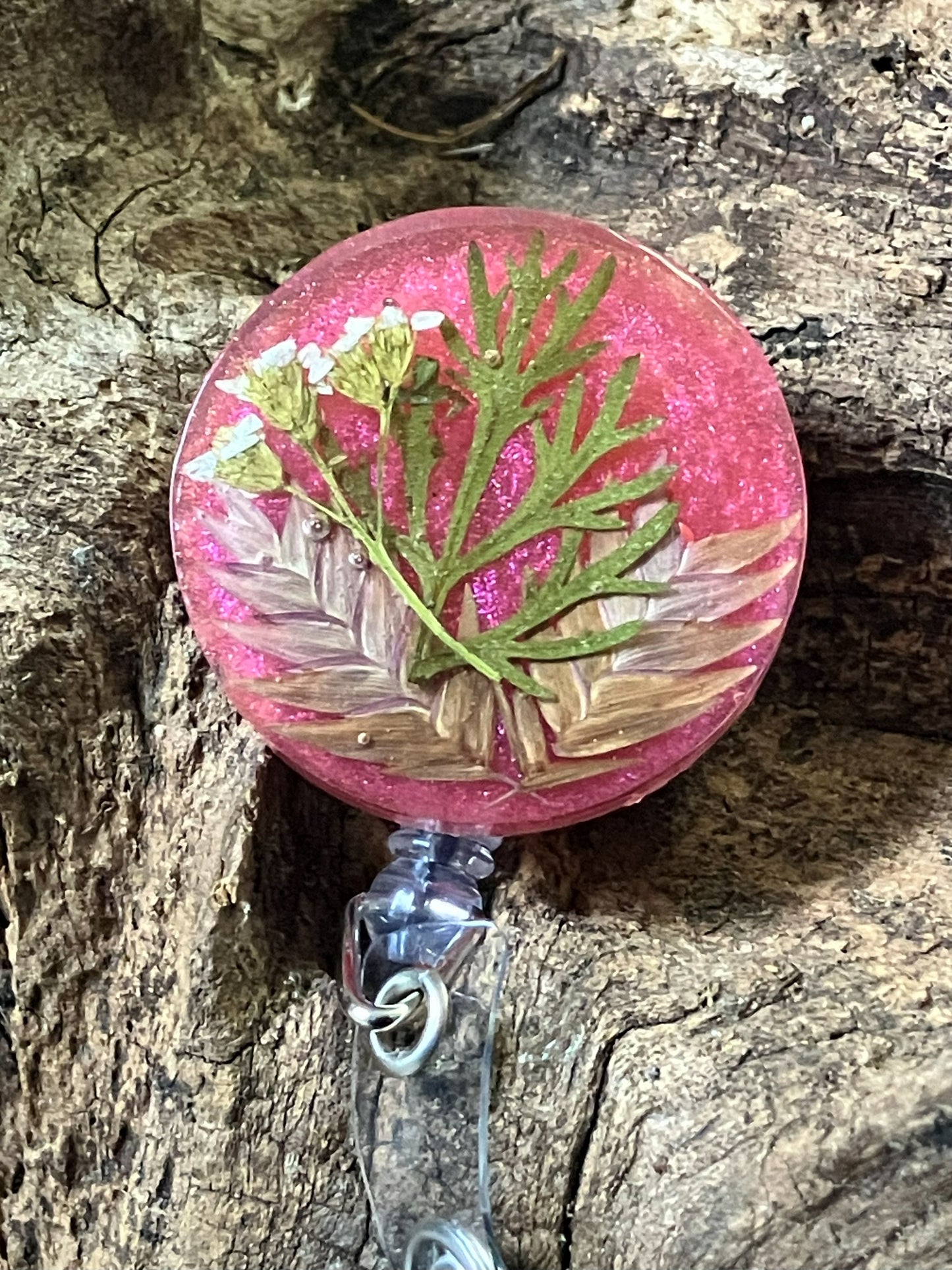 Handmade resin badge reel with real wormwood preserved inside, crafted by R & D Floral.
