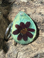 Shimmering blue-green resin keychain with real zinnia flowers, handcrafted by R & D Floral.