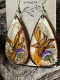 Handmade wooden earrings featuring real crocosmia, fern, and ageratum flowers encased in resin by R & D Floral.