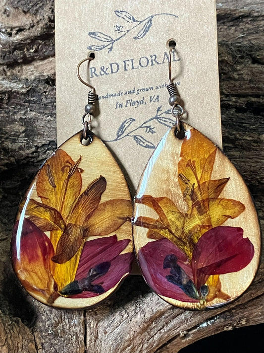 Artisan wooden earrings handmade with real crocosmia, geranium, and salvia flowers arranged like a lotus in bloom by R & D Floral.