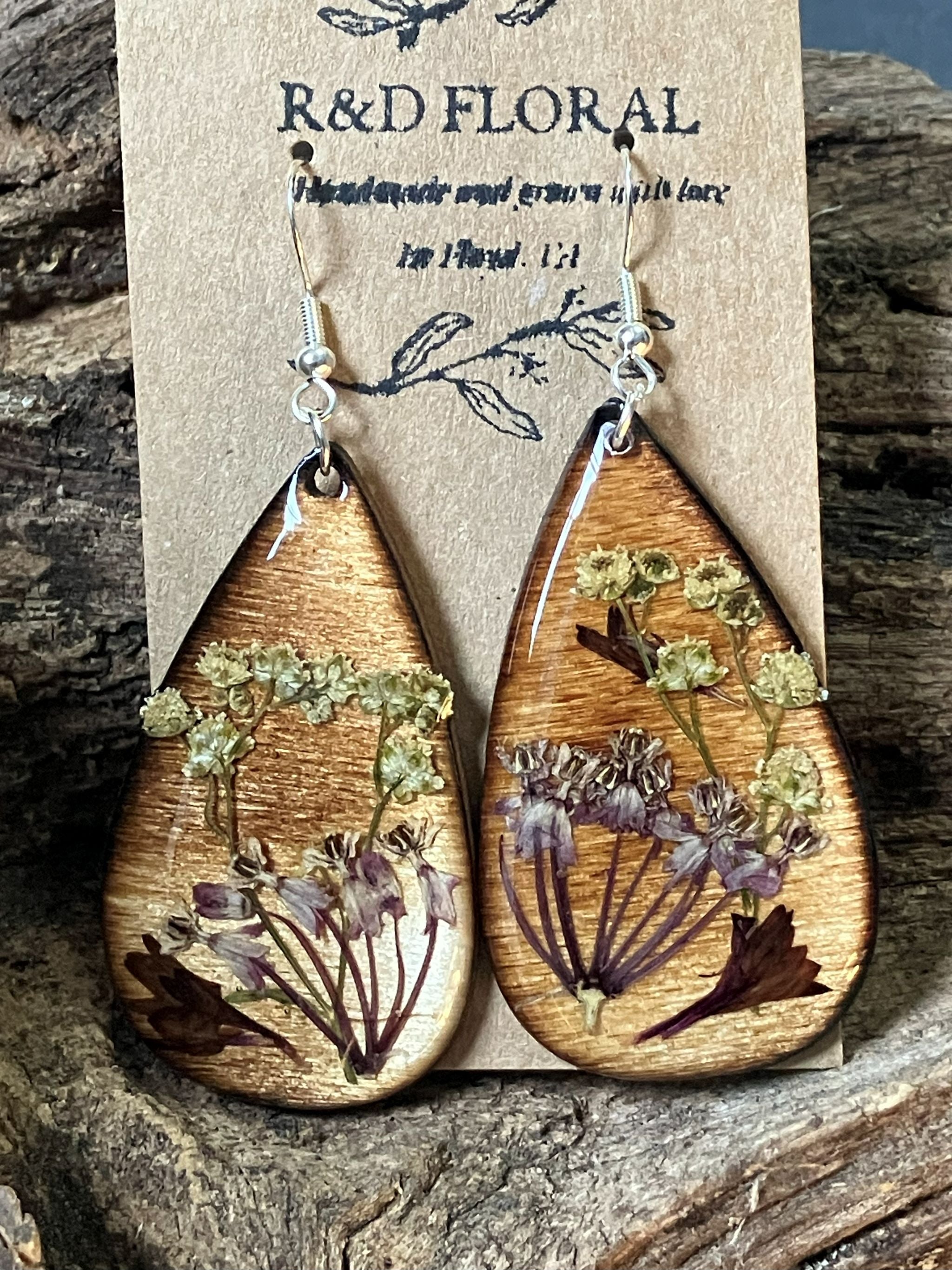 Handcrafted wooden earrings featuring real bachelor’s button and yarrow flowers in a minimalist Japanese-inspired design by R & D Floral.