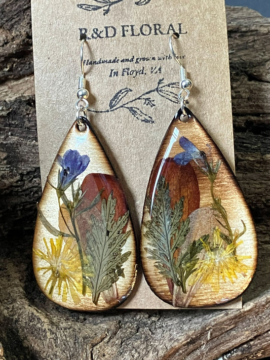Handmade wooden earrings with real dandelion, zinnia, and lobelia flowers preserved in resin by R & D Floral.