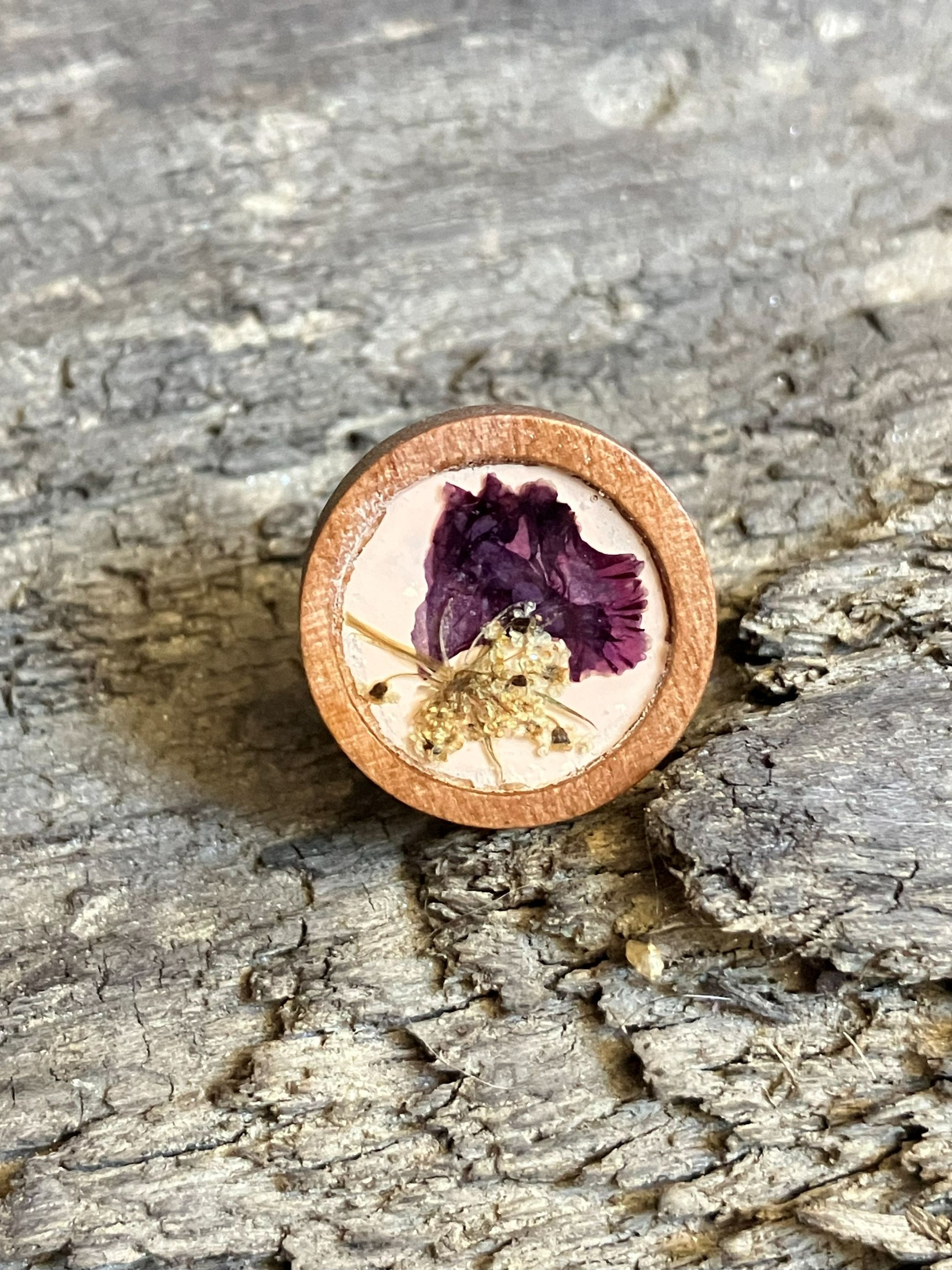 Hand-painted peach wooden stud earrings with real Queen Anne’s lace and crape myrtle encased in resin, handcrafted by R & D Floral.