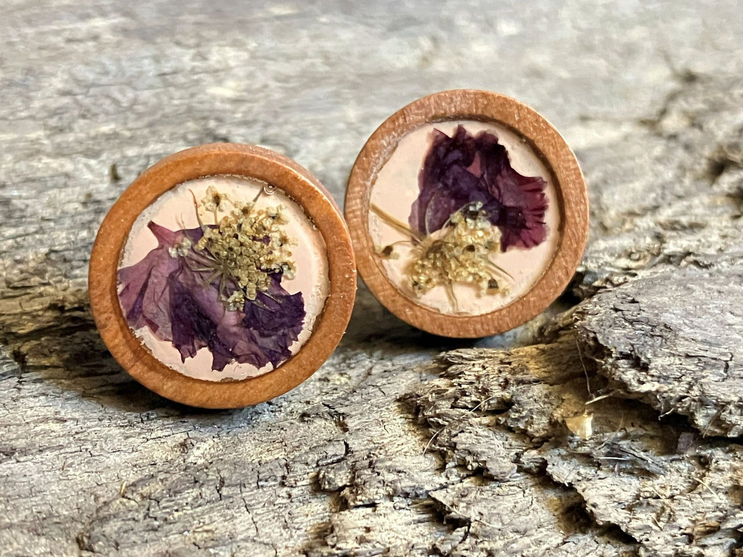 Hand-painted peach wooden stud earrings with real Queen Anne’s lace and crape myrtle encased in resin, handcrafted by R & D Floral.