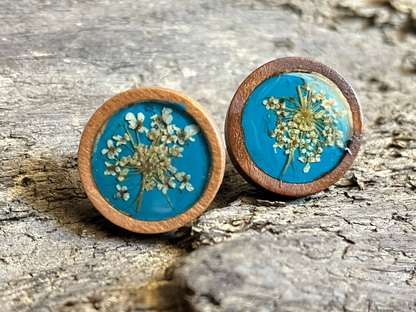 Hand-painted teal wooden stud earrings with real Queen Anne’s lace preserved in resin by R & D Floral.