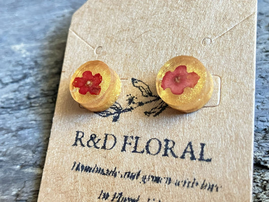 Gold circle stud earrings with real Lantana flowers encased in resin by R & D Floral.