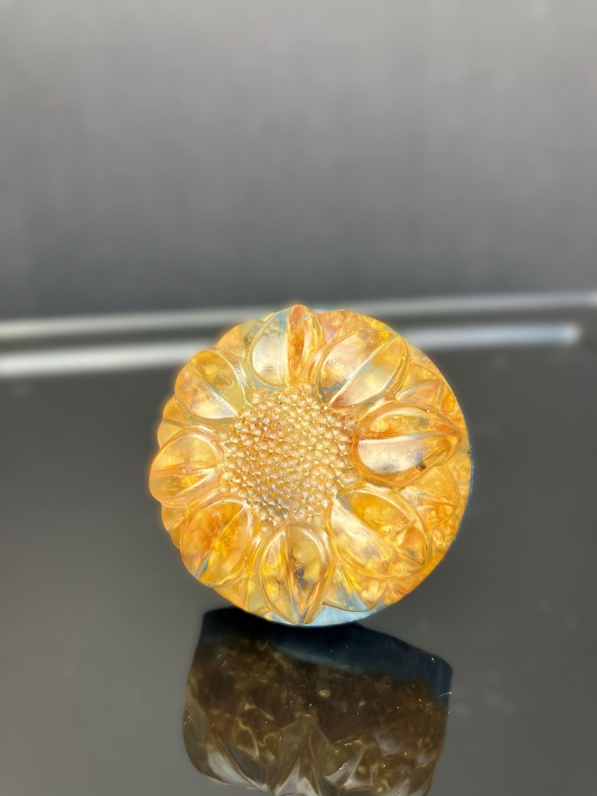 Sunny yellow clover drawer knob preserved in clear resin with a light blue background.