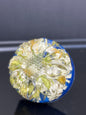 Drawer knob with real feverfew daisy-like flowers preserved in resin over a cobalt blue background.