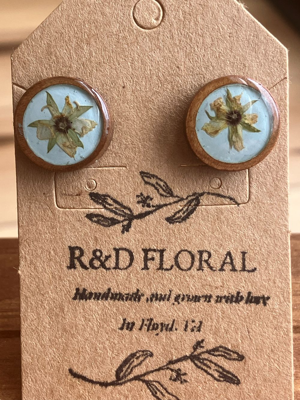 Wooden stud earrings encasing a small real Hypericum flower handmade by R & D Floral.