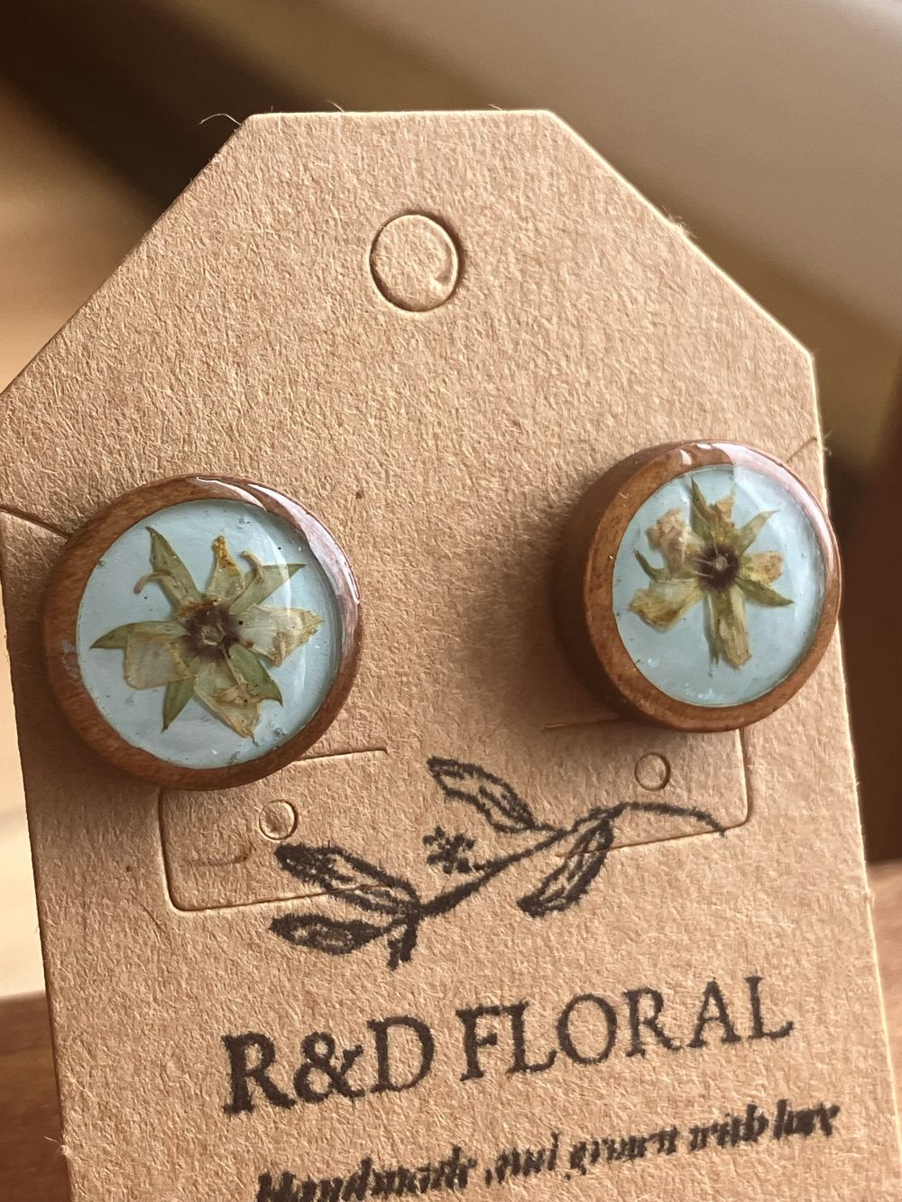 Wooden stud earrings encasing a small real Hypericum flower handmade by R & D Floral.