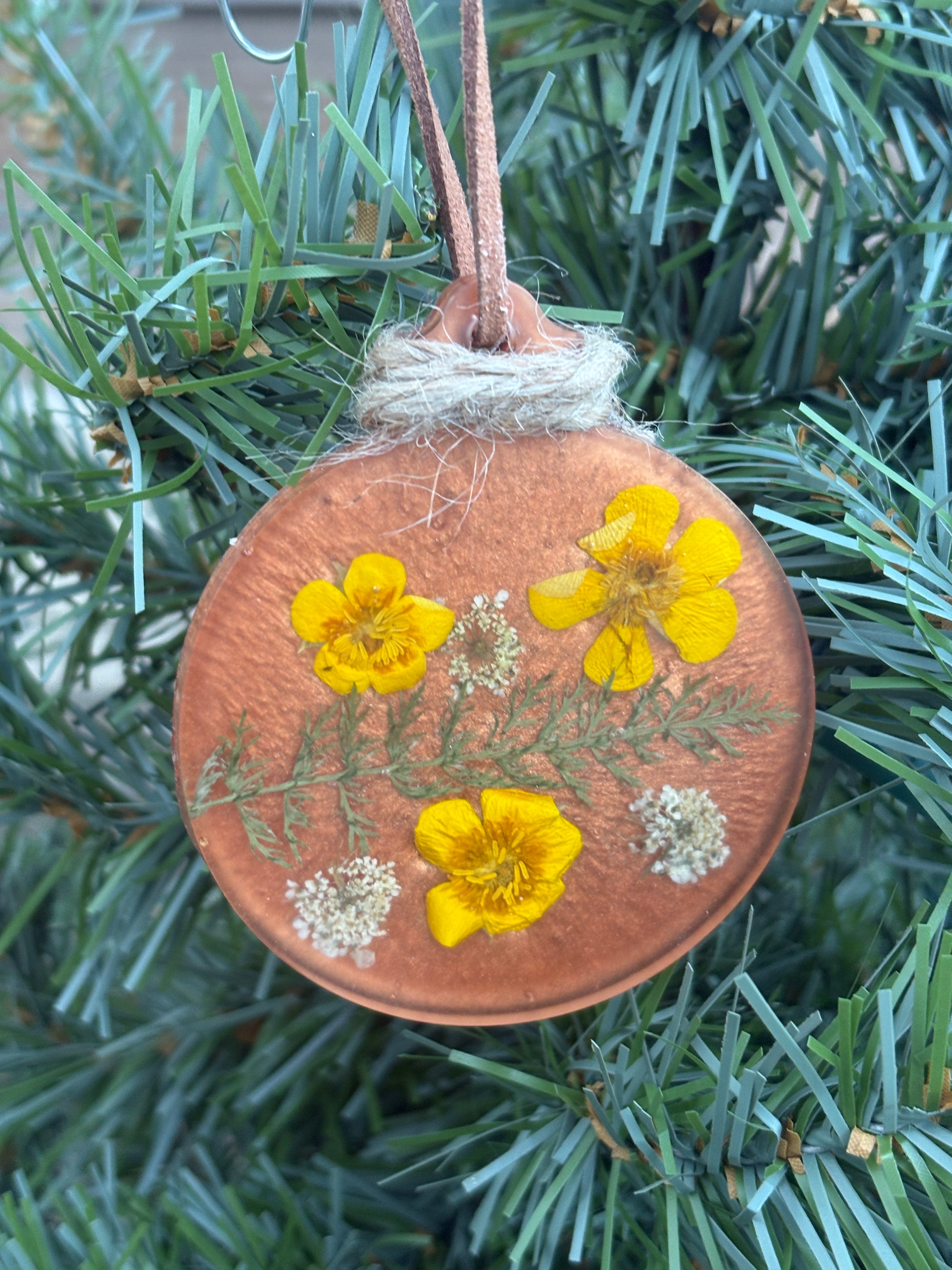 Buttercup and Queen Anne's Lace pressed flower ornament in copper resin on jute twine