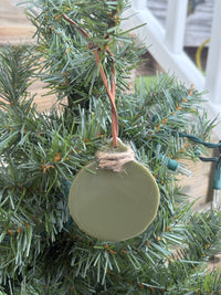 Back of the buttercup and verbena sage green resin ornament showing the smooth reverse side