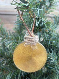 Back of the clematis gold resin ornament showing the smooth reverse side