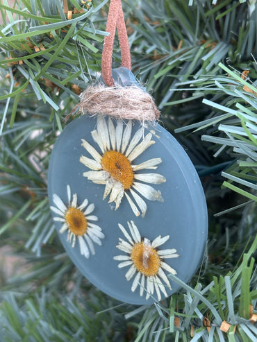 Close-up of pressed daisy ornament in grey resin