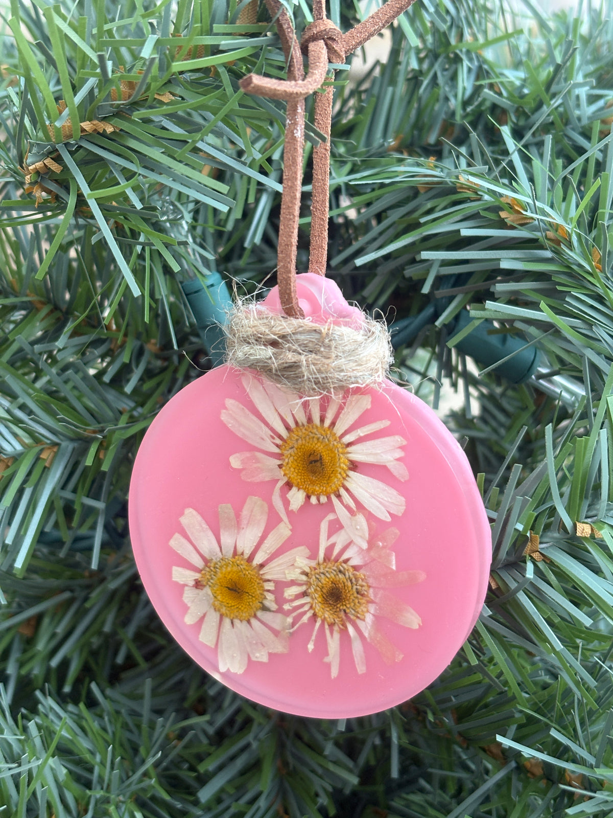 Pressed daisy ornament in pink resin on leather cord