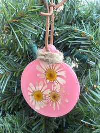 Pressed daisy ornament in pink resin on leather cord