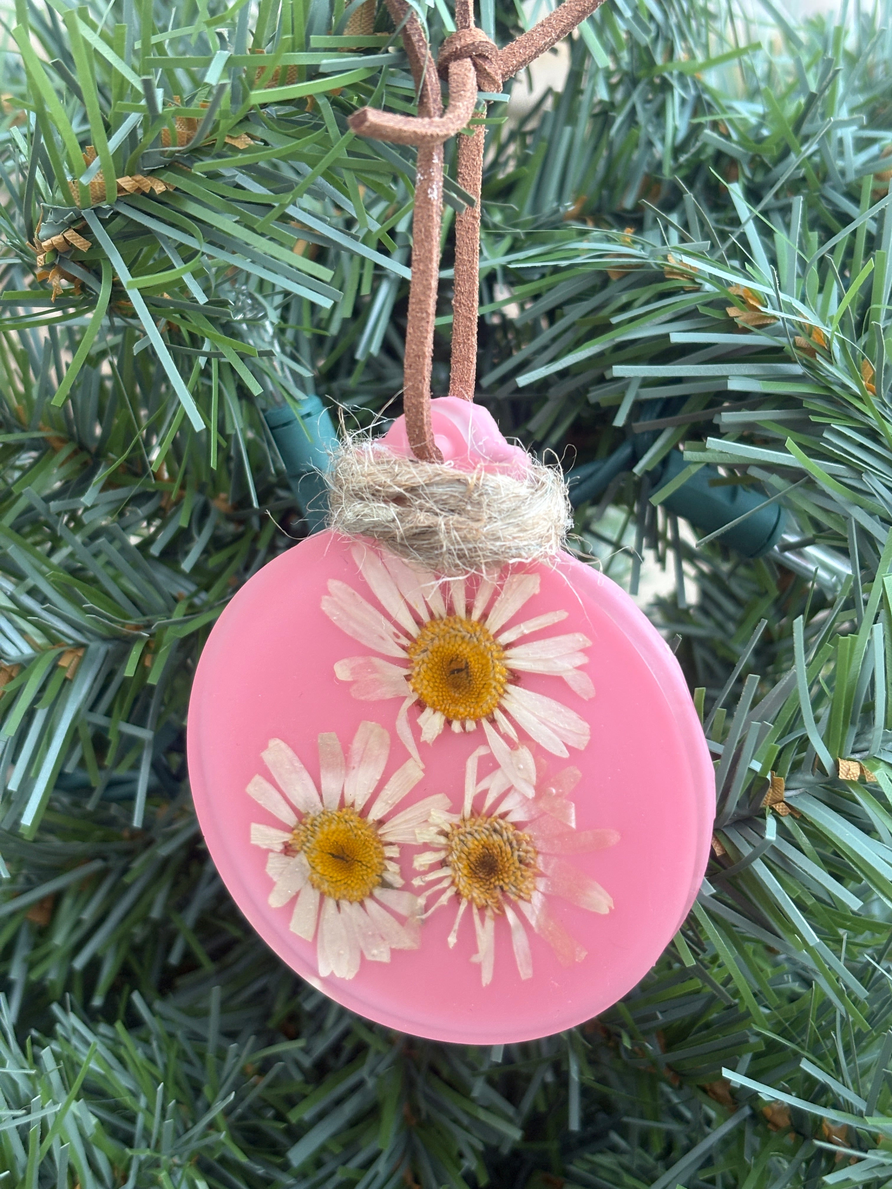 Pressed daisy ornament in pink resin on leather cord