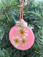 Pressed daisy ornament in pink resin on leather cord