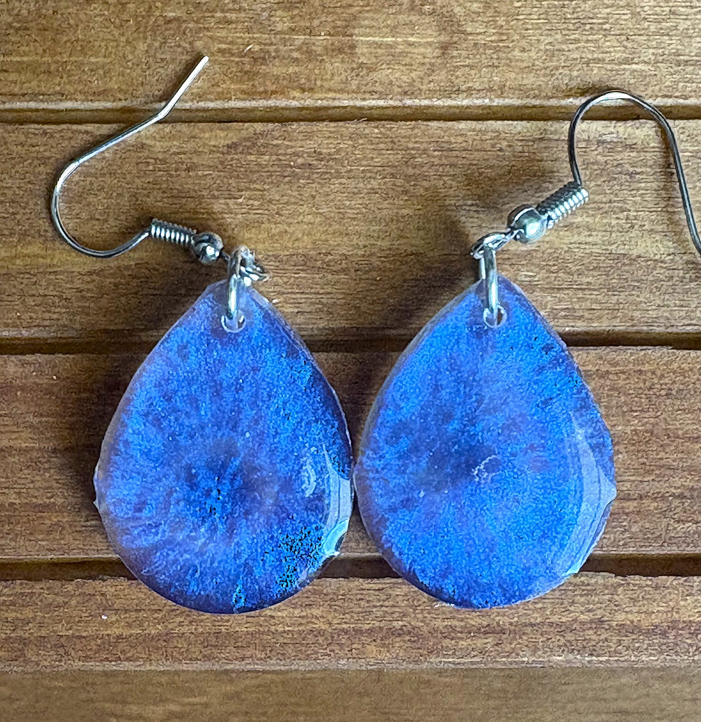 Back view of blue shimmer resin teardrop earrings showing closure
