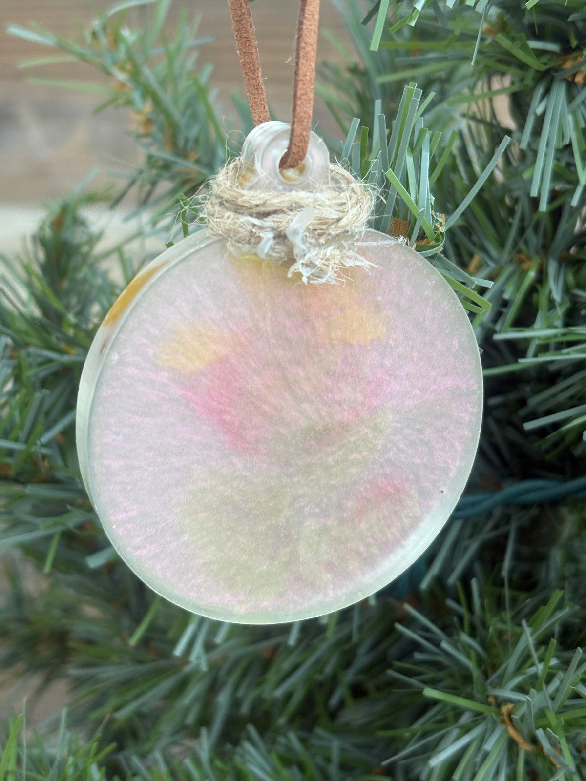Back of the fern, Salvia, and Coreopsis iridescent resin ornament showing the smooth reverse side