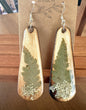 Fern and Queen Anne's Lace wooden teardrop earrings on wood grain background