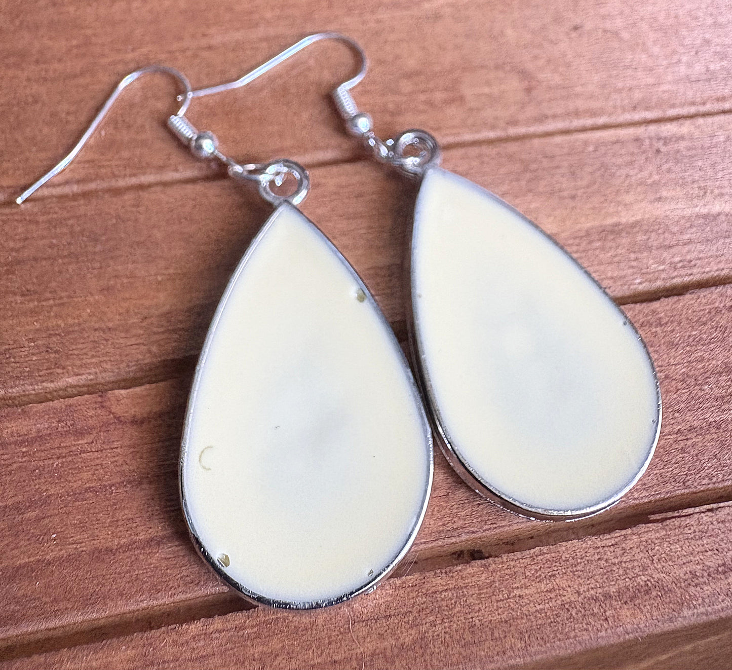 Back view of Light Yellow Metal Queen Anne's Lace Earrings showing smooth cream resin finish
