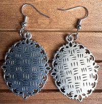 Back view of viola Victorian earrings showing ornate silver filigree metal setting detail